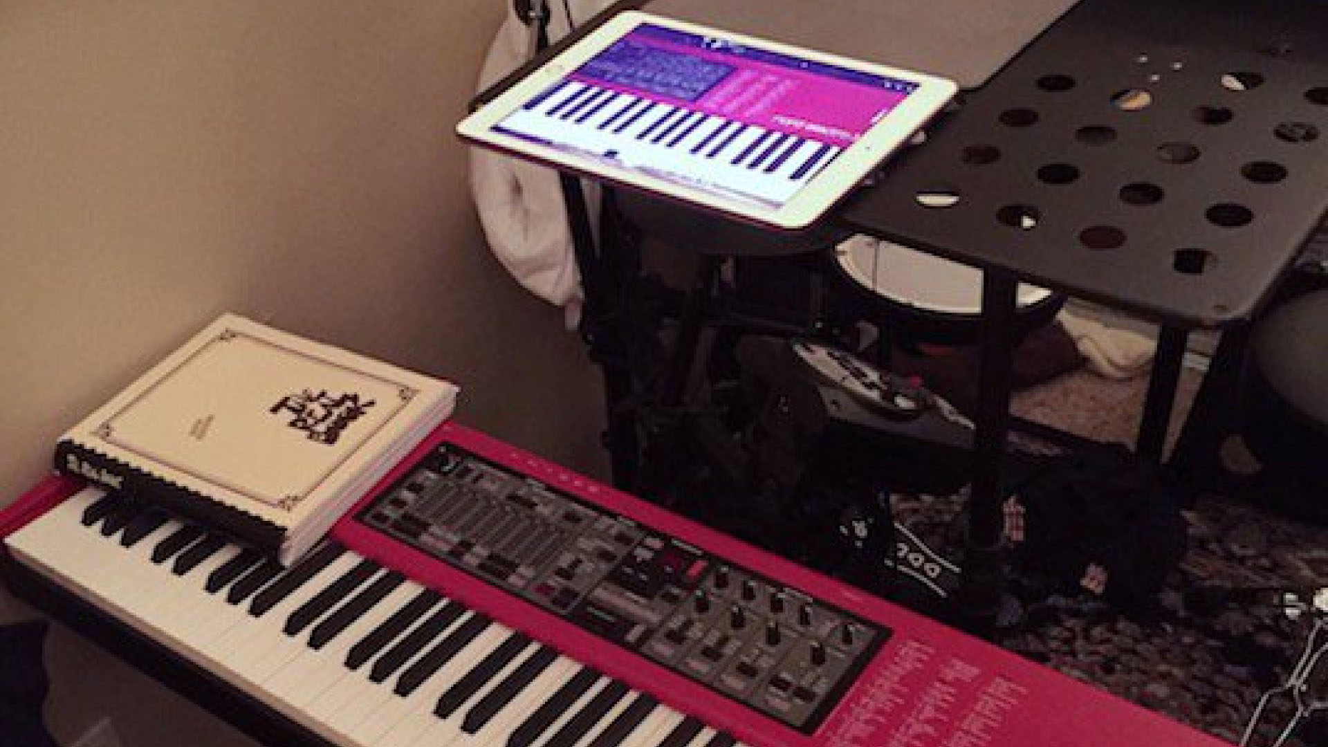 A photo of a pianist recording their performance with their phone on a stand